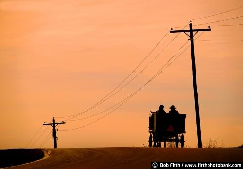 Amish;Amish horse and buggy;sunset;people;couple;orange sky;road;Wisconsin;WI;peaceful