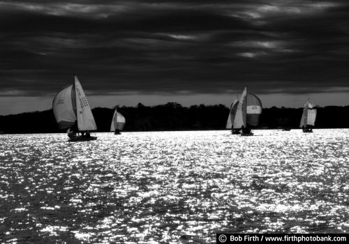 black and white photo;Lake Minnetonka;dramatic sky;Minnesota;MN;sailing;regatta;sailboats;sailing race;dark sky;mast;hull;sparkling water;recreation;water sport;boats;dramatic water