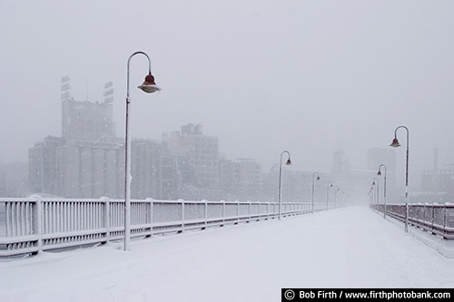 Historic JJ Hill Stone Arch Bridge;JJ Hill Bridge;lamp posts;Minneapolis;Minnesota;MN;Mpls;skyline;snow storm;winter;Stone Arch Bridge;Twin Cities