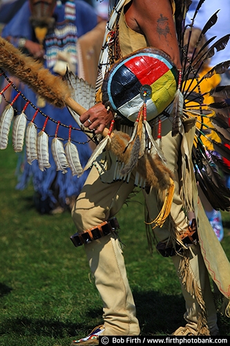 Native Americans;Native American Indians;Native American clothing;man;Pow Wow;cultural;culture;dancer;Indian dancers;powwaw;social gathering;regalia;authentic design;tradition;customs;traditional;traditional ceremonies;tribes;Wacipi;American Indian gathering;celebration of life;Men's Traditional regalia;buckskin;sticks;dance stick;traditional dancers;Circle of Life;Native American art;Circle of Life symbolism;symbolic;feathers;colorful feathers;feather bustle;feathers used by Indians;feathers used in regalia;turtle shell used with regalia;Native American Indians customs