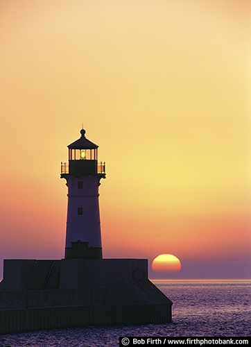 tourism;sun;silhouettes;orange sky;northern Minnesota;North Shore lighthouses;MN;Lake Superior Water Trail;Kitchi Gammi;destination;Duluth Lighthouse;sunrise;beacon