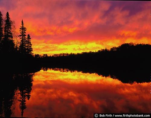 inspirational;pine trees;BWCA;Boundary Waters Canoe Area Wilderness;Boundary Waters;BWCAW;yellow sky;trees;tourism;sunrise;silhouettes;powerful;orange sky;northern Minnesota;north woods;North Shore;moody;MN;Gunflint Trail;dramatic sky;destination;colorful;calm water