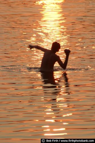 water;sunsets;summer fun;summer;silhouettes;photo;Minnesota;Minneapolis;lakes;kids playing in water;children;Cedar Lake;boy;MN;Mpls