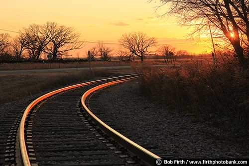 Railroad;tracks;Wisconsin;WI;railroad tracks;train tracks;transportation;sunset;sunlit tracks;industry;bare trees;trees;silhouette