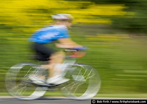 Bicycling;action shot;bicycle;bike;biker;biking;blur;Carver County MN;Carver Park Reserve;cycling;cyclist;exercise;fast;Minnesota;MN;motion;pedaling;recreation;recreational;road bike;solo;Three Rivers Park District;Victoria MN;woman