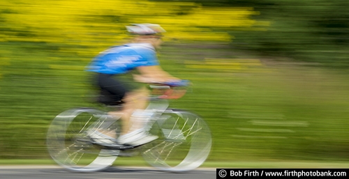 Bicycling;action shot;bicycle;bike;biker;biking;blur;Carver County MN;Carver Park Reserve;cycling;cyclist;exercise;fast;Minnesota;MN;motion;pedaling;recreation;recreational;road bike;solo;Three Rivers Park District;Victoria MN;woman;panoramic