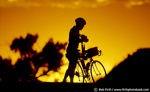 sunset;bicycle touring;bicycling;bikes;cycling;cyclist;fun pastime;exercise;recreation;Minnesota;MN;silhouette;summer;solitude;peaceful;relaxing;golden sky