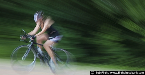 Bicycling;action shot;bicycle;bike;biker;biking;blur;cycling;cyclist;exercise;motion;pedaling;road bike;solo;sport;summer;woman;recreation;recreational;panoramic