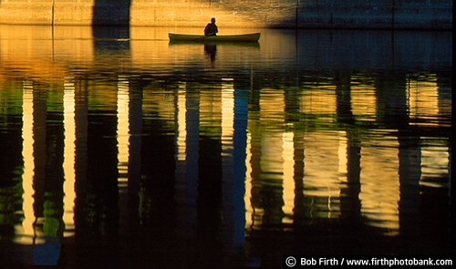 canoeing;canoe;bridge;dramatic light;fun pastime;Mississippi River;Minneapolis MN;Minnesota;morning;paddle sport;peaceful;person;recreational;reflections in water;silhouette;solitude;water sport