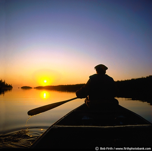 Boundary Waters Canoe Area Wilderness;BWCA;BWCAW;canoe;canoeing;fun pastime;lake;man;northern Minnesota;MN;morning;paddle sport;peaceful;person;recreational;silhouette;solitude;summer;sunrise;twilight;water sport;calm;water droplets