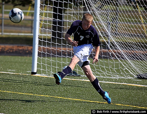 Soccer;futbol;team sport;summer;Sports;athletic;athlete;competitive;competition;competitive sport;contact sport;endurance;exercise;fun pastime;physical activity;agressive;determined;hustle;hustling;game;defense;defensive player;goal;net;kicking the ball;male;teenager;teen;young man;action;running;soccer ball;sport;clear;clearing the ball;kicker