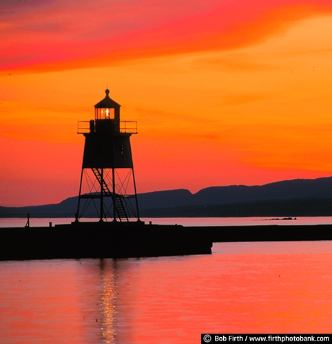 Lake Superior;Kitchi Gammi;largest freshwater lake;Minnesotas North Shore;MN;northern Minnesota;peaceful;shoreline;tourism;water;destination;biggest fresh water lake;beacon;calm water;colorful;dramatic sky;Grand Marais Lighthouse;Great Lakes;lighhouse silhouettes;moody;orange sky;Sawtooth Mountains;Sawtooth National Forest;silhouettes;sunset