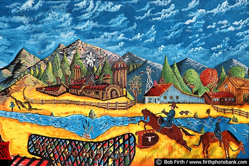 agricultural;colorful;cowboy;farm;hand painted sign;homemade;horses;horseback riding;man;mountains;mural;painting;people;ranch;river;rural;signage;wall art;wall sign;western