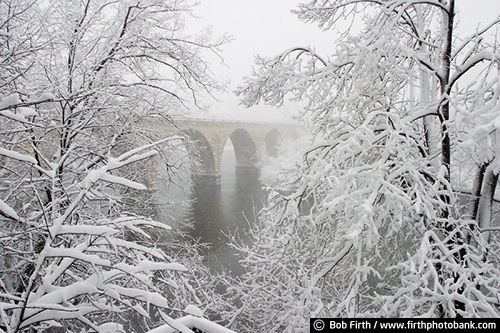 Historic JJ Hill Stone Arch Bridge;Minneapolis;Minnesota;MN;Mpls;Stone Arch Bridge;snow;trees;winter;snow covered trees;Mississippi River;Twin Cities